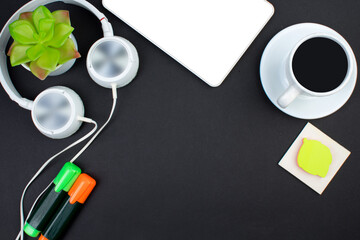 black office table with computer, pen and a cup of coffee, lot of things. Top view with copy space.