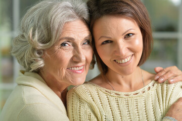 Portrait of cute senior woman with daughter
