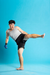 Obraz premium Image of Asian man exercising on blue background