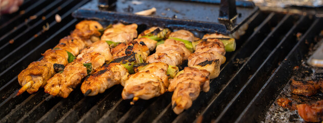 Grilling barbecue meat skewer kebab at traditional night market in South Korea.