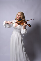 Close up portrait of beautiful blonde model wearing elegant  white halloween gown, a historical...