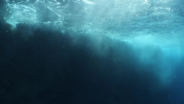 choppy water wavy sea underwater wave hit on rocks and makes foam on the surface of the sea ocean scenery backgrounds