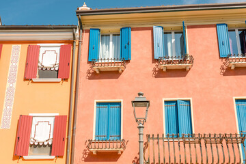 Caorle Venice, Italy - September 4, 2023: Colorful facade with windows and terrace - 646794670