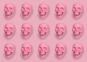 pastel pink skulls pattern on pink background halloween concept