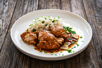 Hawaiian chicken style - shoyu chicken thighs with white rice on wooden table
