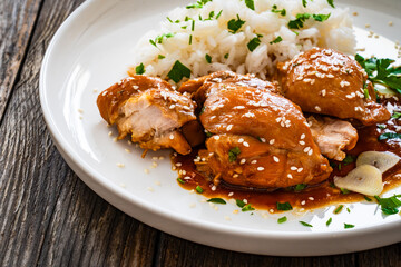 Hawaiian chicken style - shoyu chicken thighs with white rice on wooden table
