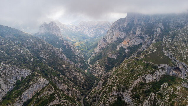 La Hermida gorge and the Picos de Europa with looming clouds. Cantabria, Spain. - Powered by Adobe
