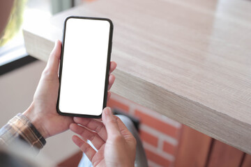 cell phone blank white screen mockup.hand holding texting using mobile on desk at office.background empty space for advertise.work people contact marketing business,technology - obrazy, fototapety, plakaty