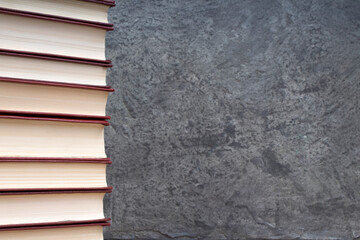 stack of books on the gray concrete background. Back to school. Education. Copy space for text.