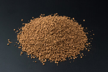 Instant freeze-dried coffee on black background