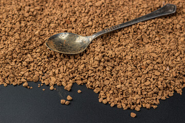 Instant freeze-dried coffee on black background