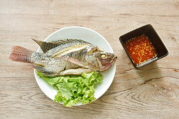 steamed mango fish with lettuce dipping spicy sauce on plate 