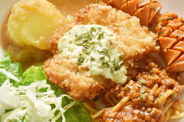 crispy fried chicken meat stuffed cheese with mash potato dressing gravy sauce and spaghetti and cabbage cos lettuce salad couple sausage on plate 