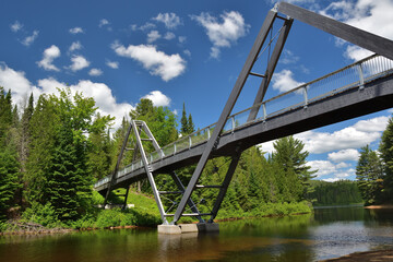 La Mauricie National Canada Park famous pedestrian bridge over Wapizagonke lake on a sunny day