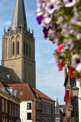 Traditional historic medieval houses in the old picturesque town of Doesburg, Gelderland, Netherlands, with the bell tower of Martinikerk church