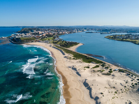 Aerial view along Nobbys Beach Newcastle on quiet sunlit winter day looking towards the city