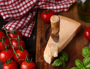 hard Italian parmesan cheese on a wooden board