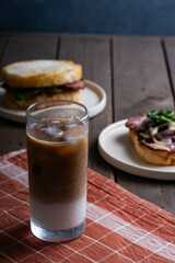 ice coffee latte with open side prosciutto and prosciutto sandwich
