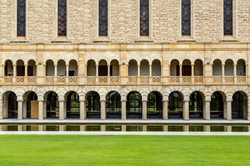 Old stone building with ornate arches and windows.