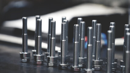 stainless partially threaded hex bolts and washers on a mechanic table background. assembly area machinery mechanical workshop. - 646815068