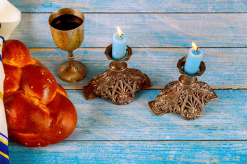 Festive sabbath traditional celebration featuring homemade challah bread, kosher wine, candles