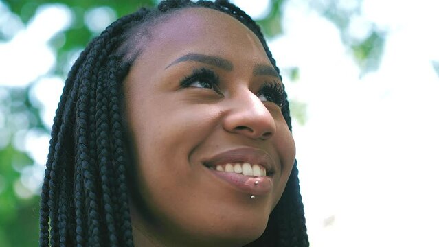 Confidence, Hope - Young Hispanic Woman Looks At The Sky And Smiles Comforted