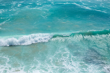 Beautiful view of the blue wave with white foam. Peak waves in the ocean