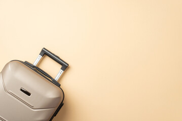 Embrace autumn wanderlust while traveling ! Top-down view of an elegant grey suitcase resting on a tranquil beige backdrop, offering ample copyspace for your advertising or text needs - obrazy, fototapety, plakaty