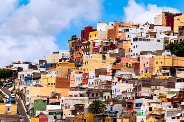 Photo of the colorful houses in the town of San Juan, Las Palmas de Gran Canaria, in the Canary Islands, taken in July. - obrazy, fototapety, plakaty