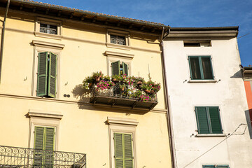 Fototapeta na wymiar Horizontal image of a buildings with windows and balcony in Porretta, Italy.