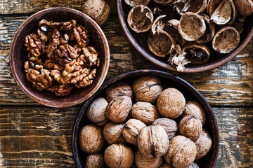 Bowl of organic walnuts on wooden table, autumn harvest time
