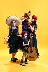 Dead mexican family with sombrero on halloween night. Studio shot of zombies isolated on yellow background. day of the dead. trick or treat