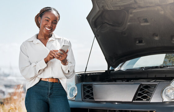 Car insurance, phone or portrait of happy woman on road for an engine crisis typing a message for help. Smile, mobile app or African driver by a stuck motor vehicle texting on social media or online