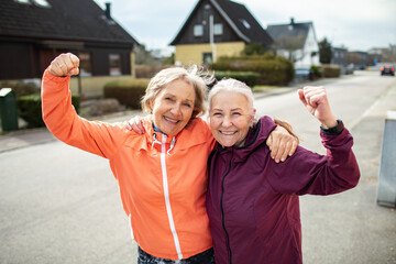 Portrait of a Senior lesbian couple jogging and exercising in the suburbs