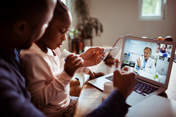 Worried single father talking to the doctor over a video call about his sick daughter