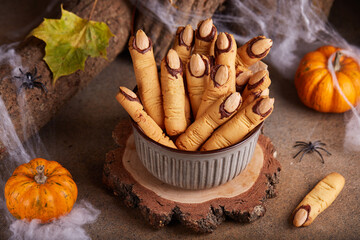 Halloween cookies witch`s fingers with chocolate and almond nuts. Delicious and scary dessert for...