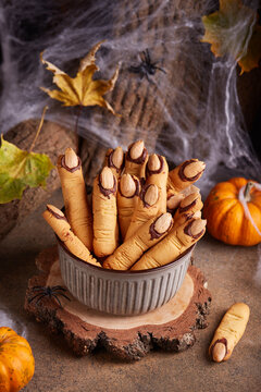 Halloween cookies witch`s fingers with chocolate and almond nuts. Delicious and scary dessert for treats.