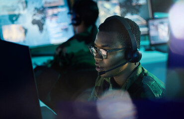 Military control room, computer and man with headset, support or tech for communication. Security, surveillance and soldier at help desk in army office at government cyber intelligence command center - obrazy, fototapety, plakaty