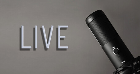 A studio condenser microphone with LIVE written on a dark background.