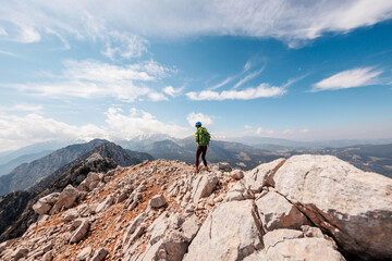 A girl with a backpack on a hike. adventure in the mountains. hiking with a backpack. girl with a...