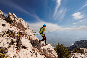 A girl with a backpack on a hike. adventure in the mountains. hiking with a backpack. girl with a...