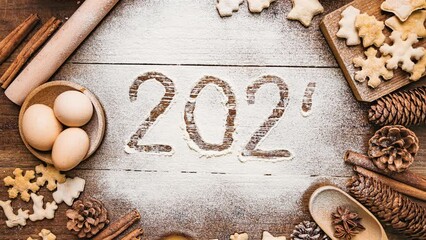 Merry Christmas and Happy New Year 2024.The freeze frame video of the number 2024 appearing on the flour on the table,