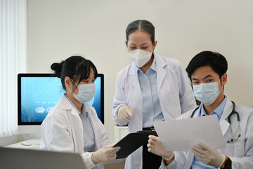 A middle-aged female medical professional advises a medical student on a microbiology research case...