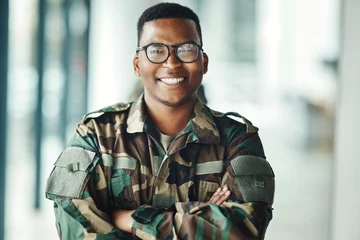 Deurstickers Lengtemeter Portrait of soldier with smile, confidence and pride at army building, arms crossed and happy professional. Military career, security and courage, black man in camouflage uniform at government agency
