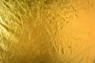 shiny gold color with creases texture abstract background