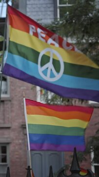 LGBTQ peace flag waving, New York City, vertical phone background, social media story