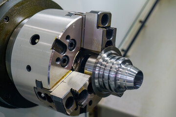 The  CNC lathe machine forming  cutting the metal cone shape parts.