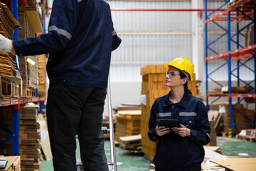 Warehouse workers checking the inventory. Products on inventory shelves storage. Worker Doing Inventory in Warehouse. Dispatcher in uniform making inventory in storehouse. supply chain concept