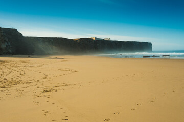 Beautiful beaches of fine sand and high, slender cliffs, one morning, in the Algarve.