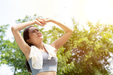 Naklejka na ściany i meble Sport asian woman gets tired and get dizzy, feel bad pain and suffer from heat stroke outdoors when jogging or exercise outdoor with strong sunlight in summer season. Heatstroke and heat wave concept.